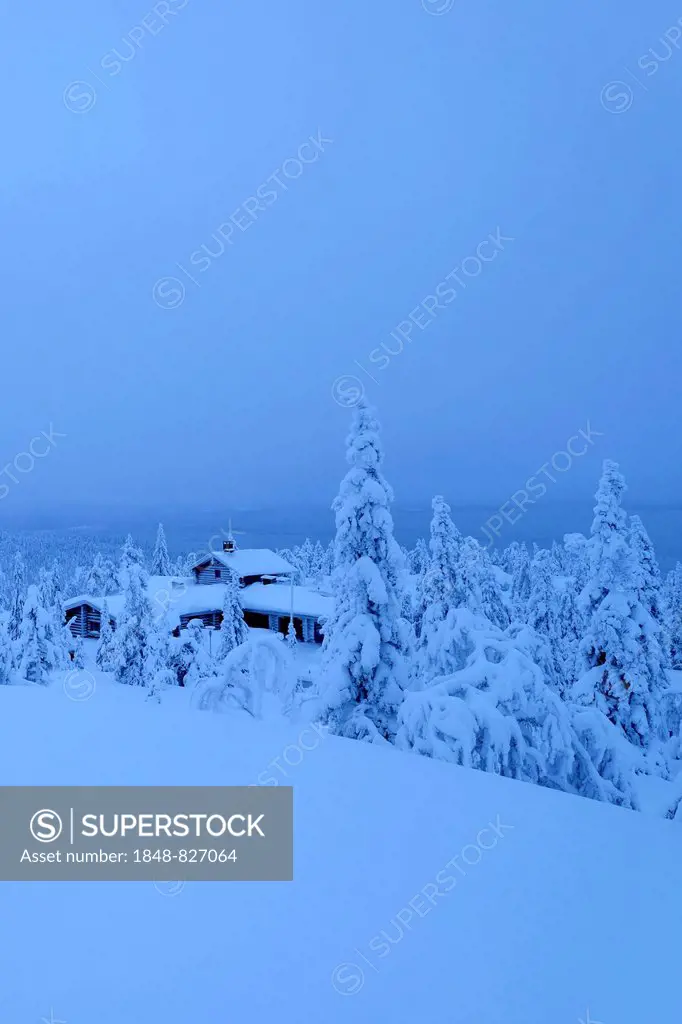 Finnish log cabin in the snow-covered landscape, Iso Syöte, Lapland, Finland