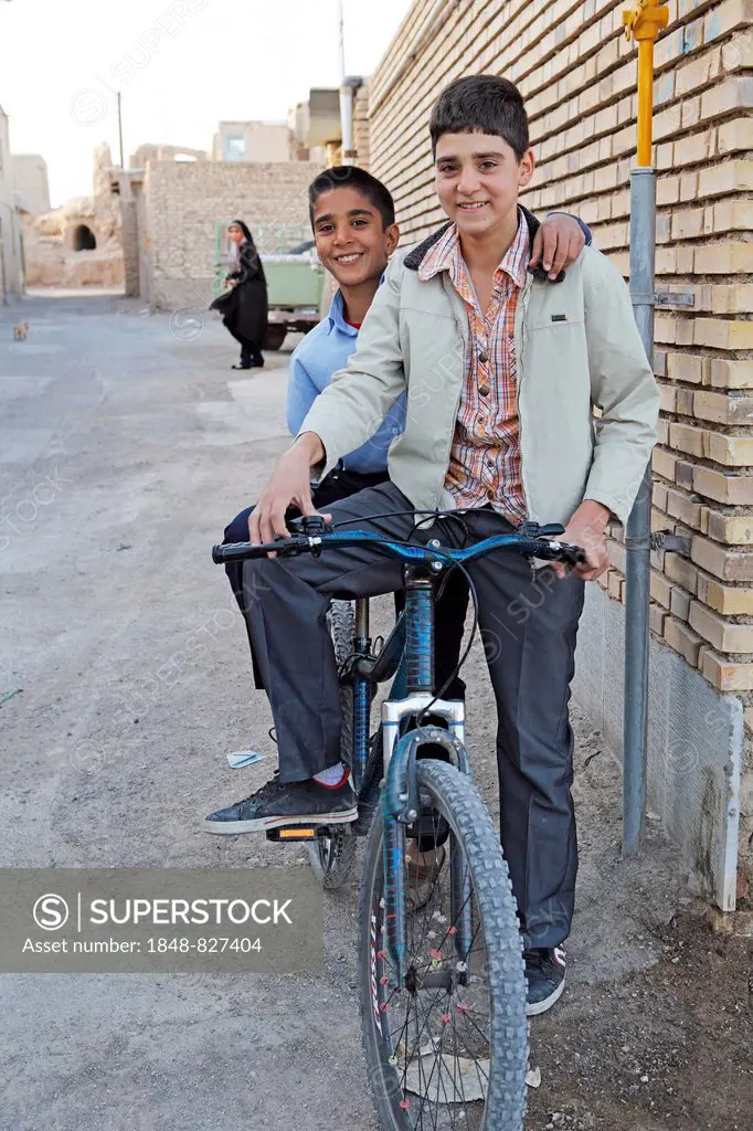 Boys with a bicycle in a residential alleyway, Na'in, Isfahan Province, Iran