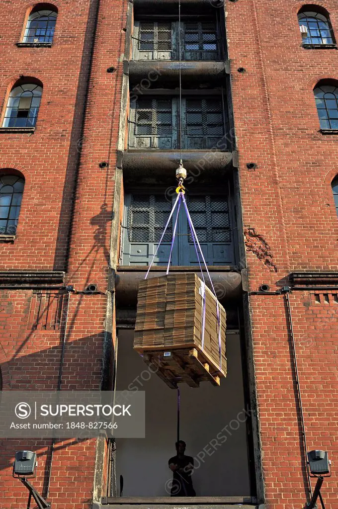 Cardboard boxes are lifted into storage, storehouse in the Speicherstadt historic warehouse district, Hamburg, Germany