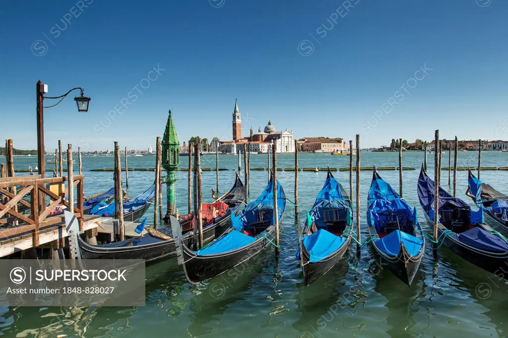 Gondolas at the Riva degli Schiavoni, San Giorgio Maggiore at the back, Venice, Italy