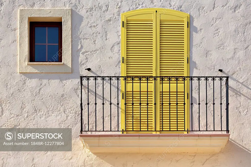 White house facade with a balcony, a yellow balcony door and a small window, Villaricos, Cuevas del Almanzora, Almería province, Andalucía, Spain