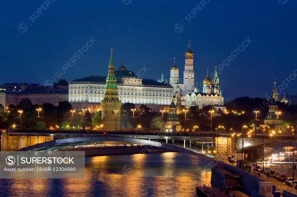 Moscow Kremlin with cathedrals and palace and Bolshoy Kamenny Bridge on Moskva River at night, Moscow, Russia