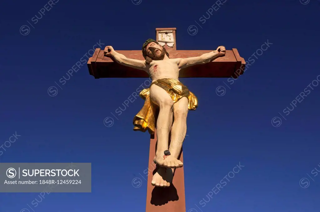 Colored stone crucifix, against a blue sky, Ringsheim, Baden-Württemberg, Germany