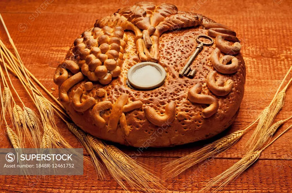 Decorated bread loaf with a key and salt shaker baked into the bread, traditional gift for a house move