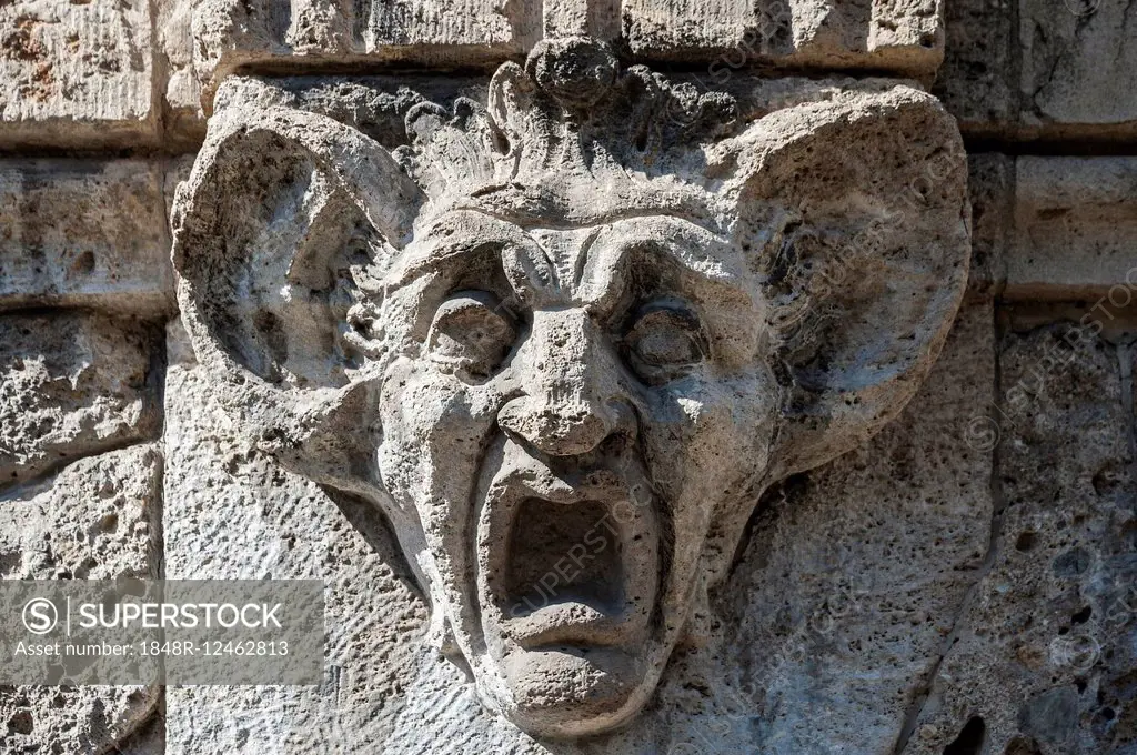 Stone carving, head with huge ears and wide open mouth, Munich, Bavaria, Germany