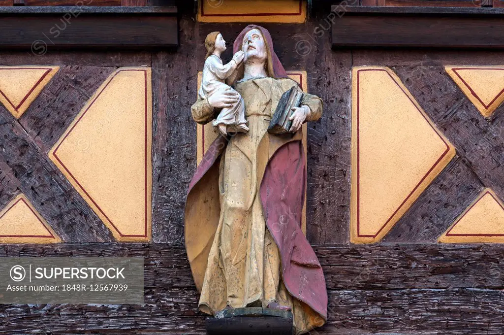 Wood-carved Mary holding the Infant Jesus at an old half-timbered house, Ettenheim, Baden-Württemberg, Germany