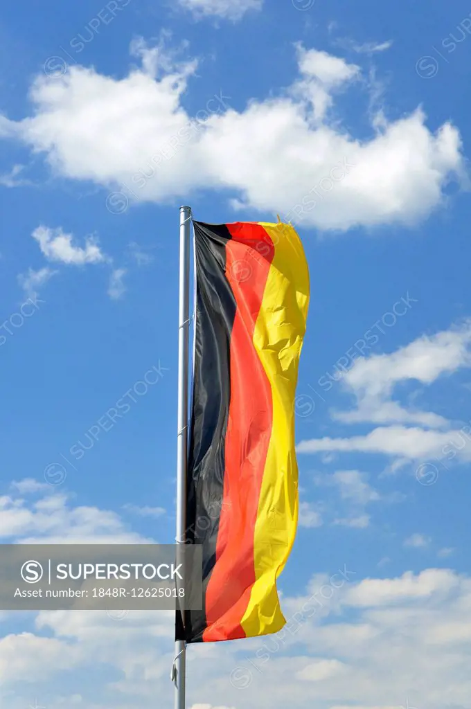 German national flag, upright, in front of clouded sky, Baden-Württemberg, Germany