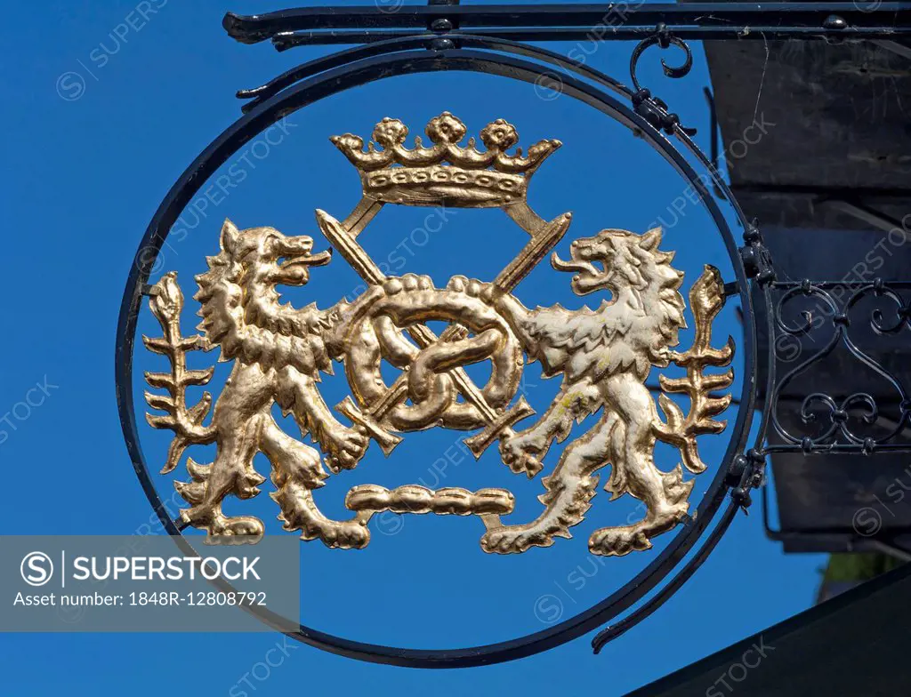 Bakery signboard with lions and pretzel, blue sky, Hitzacker, Lower Saxony, Germany