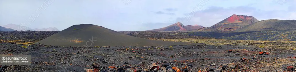 Caldera de la Rilla in the lava fields, volcanic mountains behind, Mancha Blanca, Lanzarote, Canary Islands, Spain