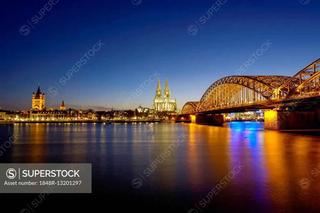 Church St Martins and Cologne Cathedral with Hohenzollern Bridge over the Rhine, Dusk, Cologne, North Rhine-Westphalia, Germany