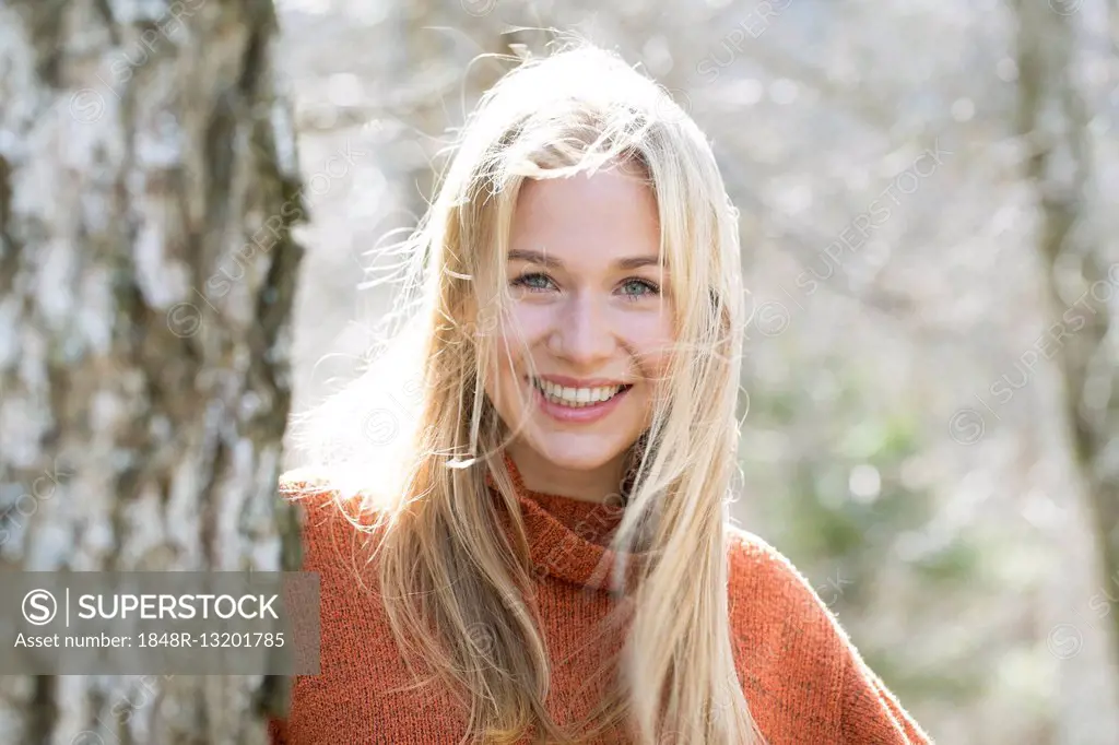 Portrait of a laughing young woman with long blond hair
