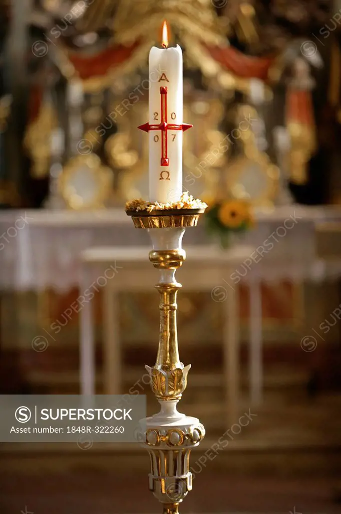 Candle burning in front of an altar