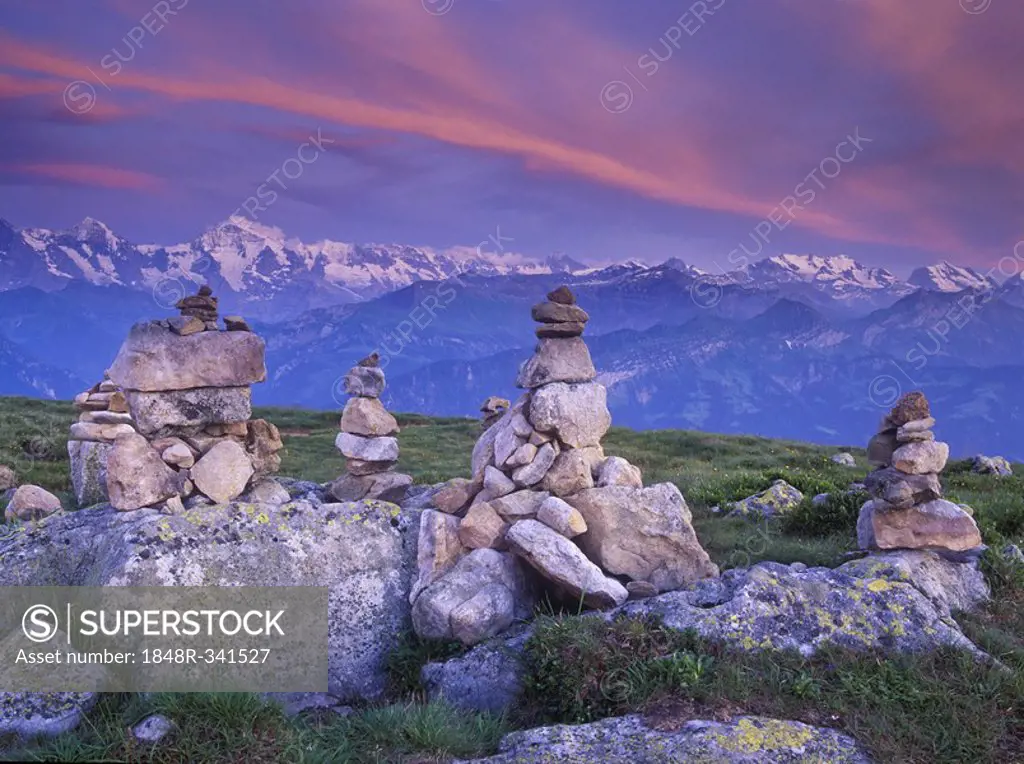 Steinmandli, piled stone cairns, at dusk, Niederhorn Mountain, Bern, Switzerland, Europe