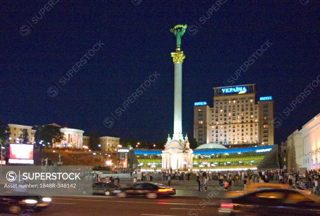 Ukraine Kiev Place of Independence with column of independence building of national akademie of music Cajikovskij Conservatorium right side and ilumin...