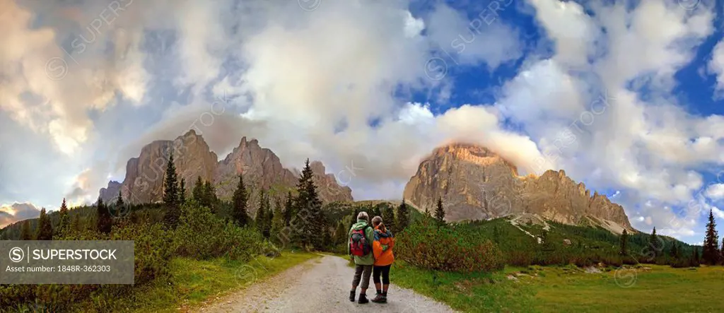 Mother and child standing in front of the Sella massif between the Passo Pordoi and Passo Sella, Bolzano-Bozen, Italy, Europe