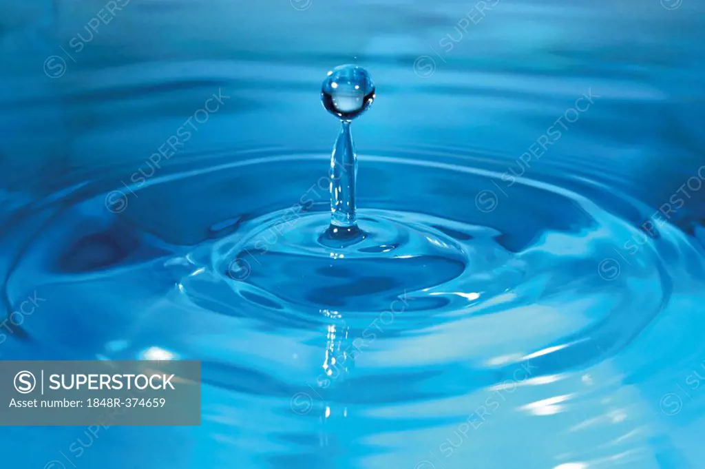 Water drop striking water, blue