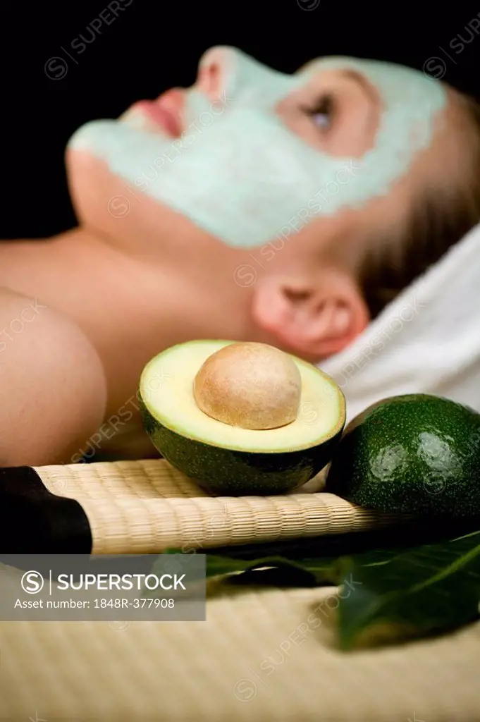 Young woman with a facial avocado mask