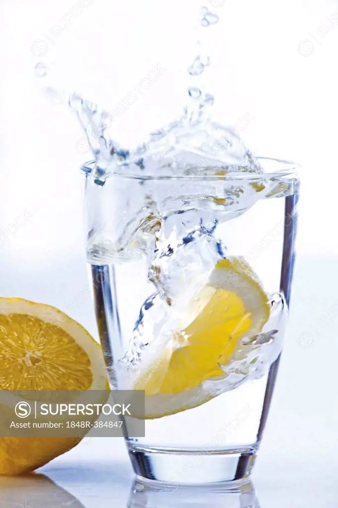 Lemon falling in a glass of water
