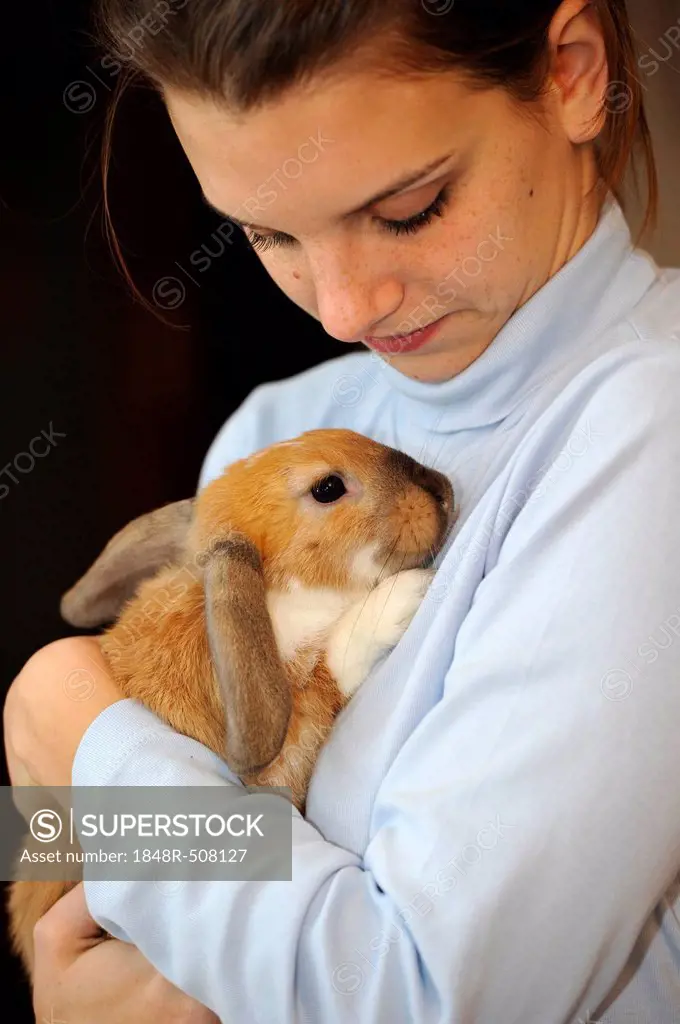 Girl with young English Lop rabbit