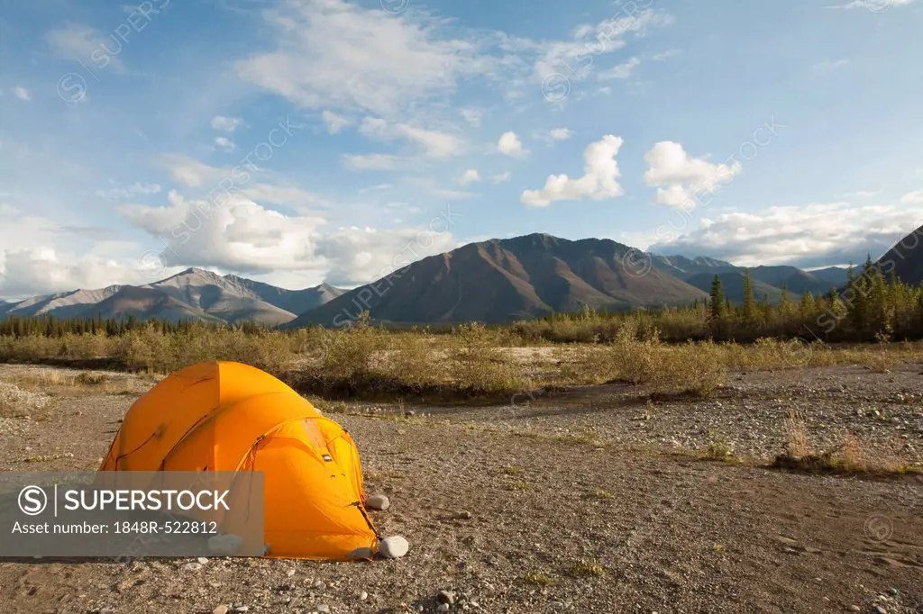 Expedition tent on a gravel bar, Northern Mackenzie Mountains behind, camping, Wind River, Yukon Territory, Canada