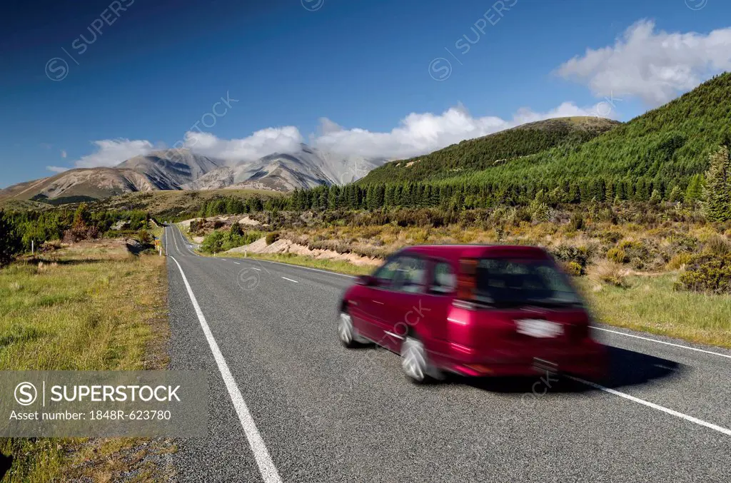 Red car driving on a country road, driving on the left, Arthur's Pass Road, South Island, New Zealand, Oceania