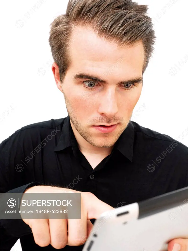 Young businessman working on an iPad, startled