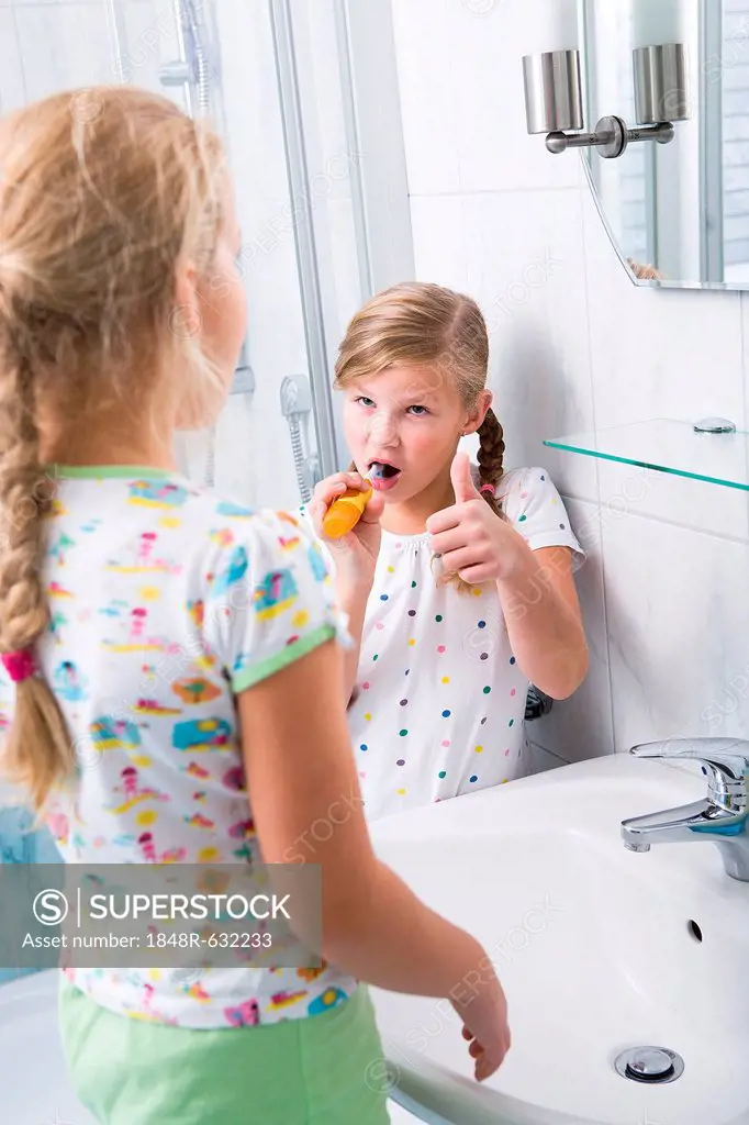 Sisters brushing teeth in the bathroom