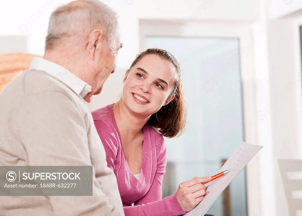 Young woman discussing a contract with an elderly man