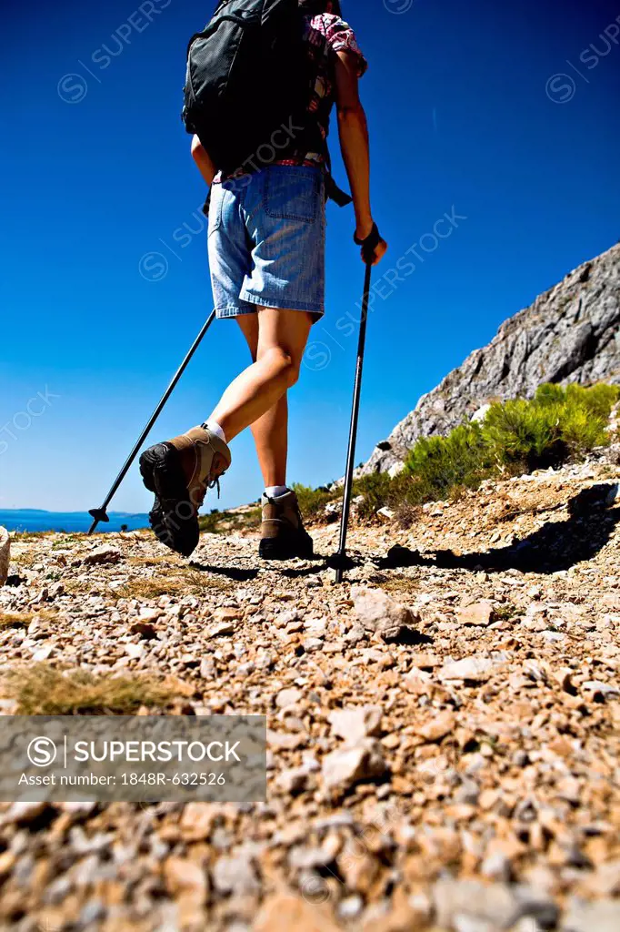 A woman hiking at the Adriatic coast near Split, Croatia, Europe