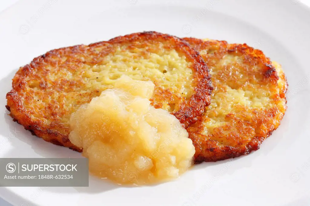 Two potato pancakes with apple compote on a plate