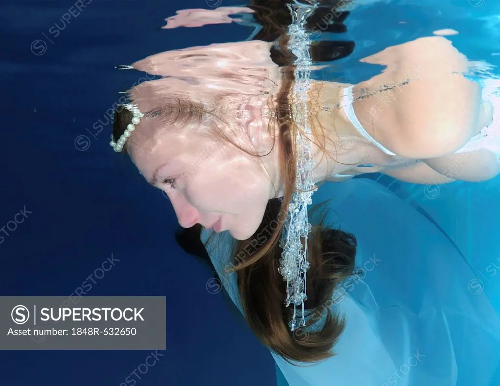 Bride, underwater wedding in pool