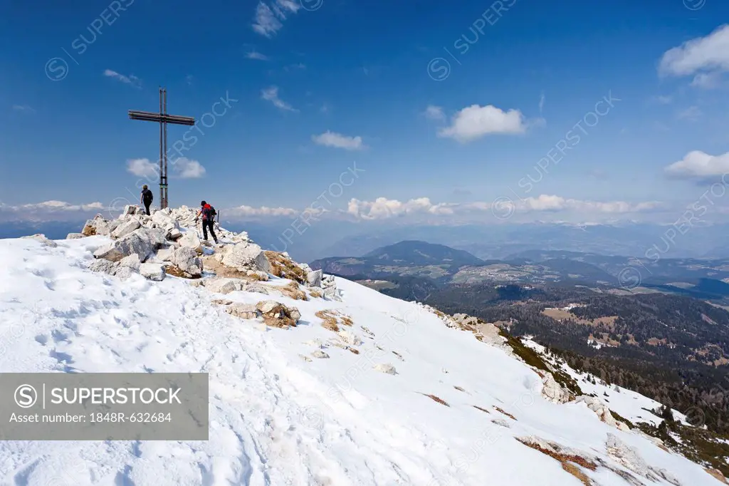 Hikers standing on the summit of Weisshorn mountain above Radein and the Bletterbachschlucht gorge, province of Bolzano-Bozen, Italy, Europe