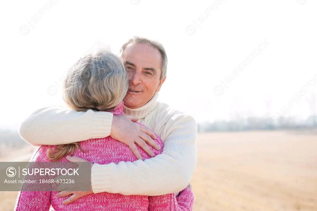 Senior man hugging his partner