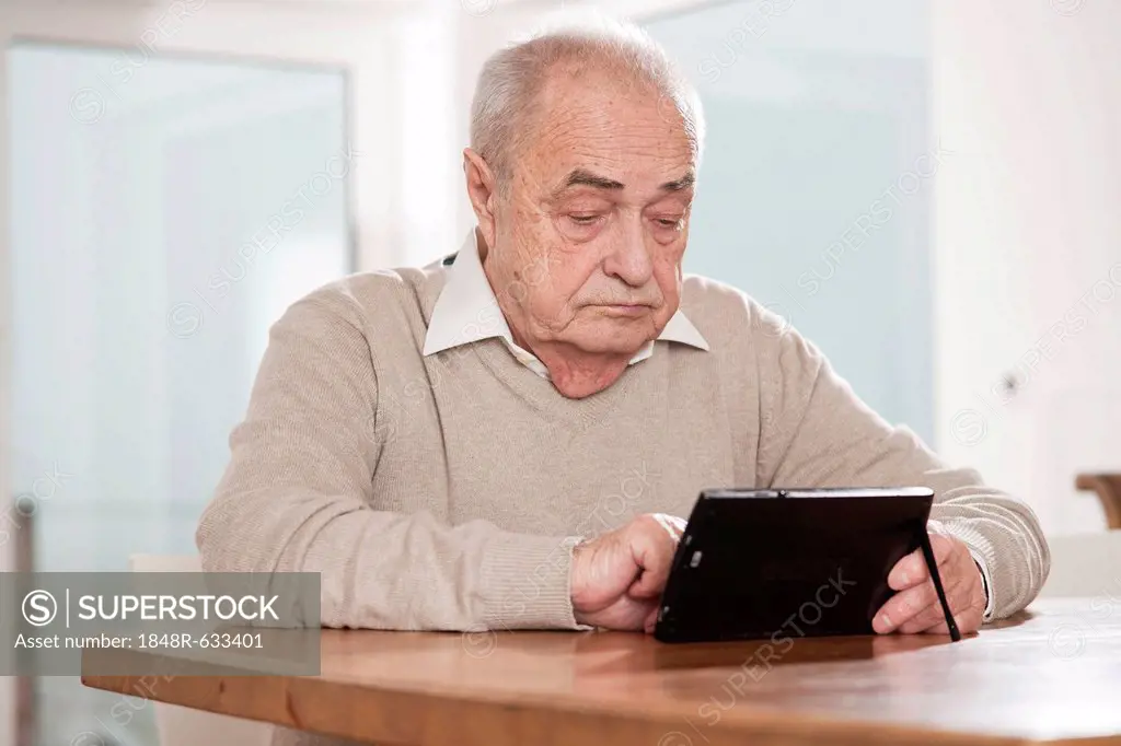Elderly man using a netbook