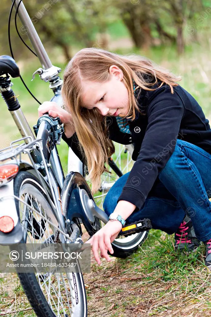 Girl checking her bicycle