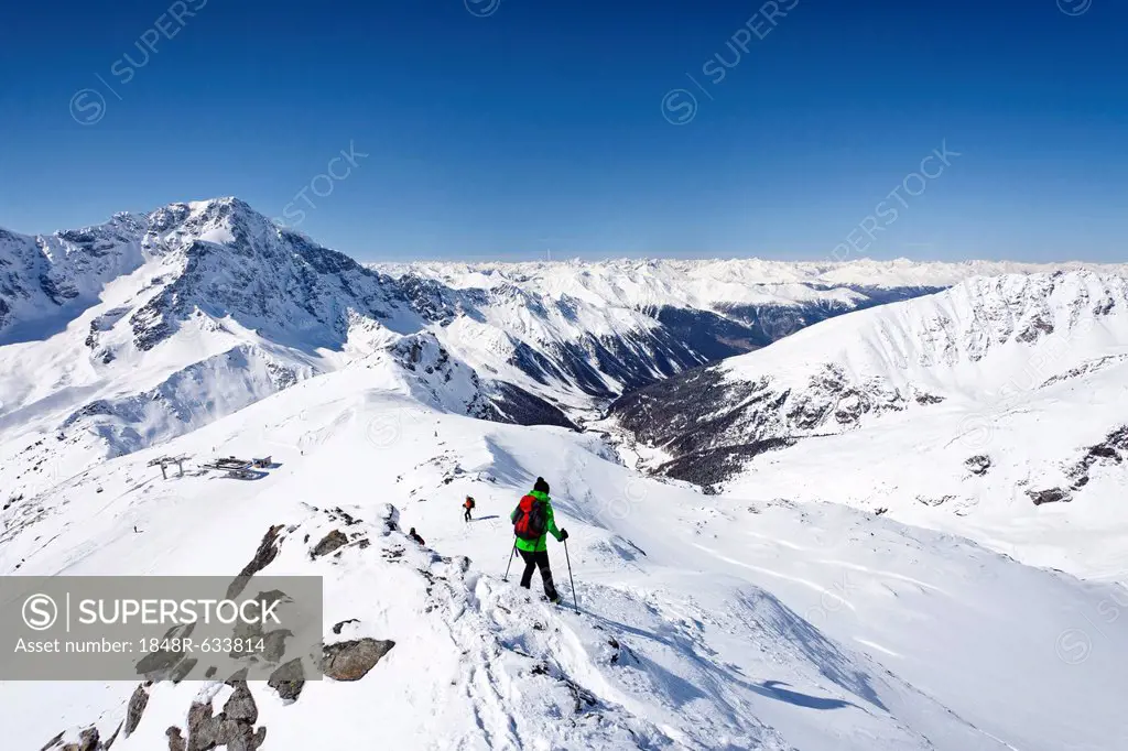 Ski tourer descending Mt Hintere Schoentaufspitze or Punta Beltovo di Dentro, Mt Ortler or Ortles and Suldental or Val di Solda in the back, Sulden, S...