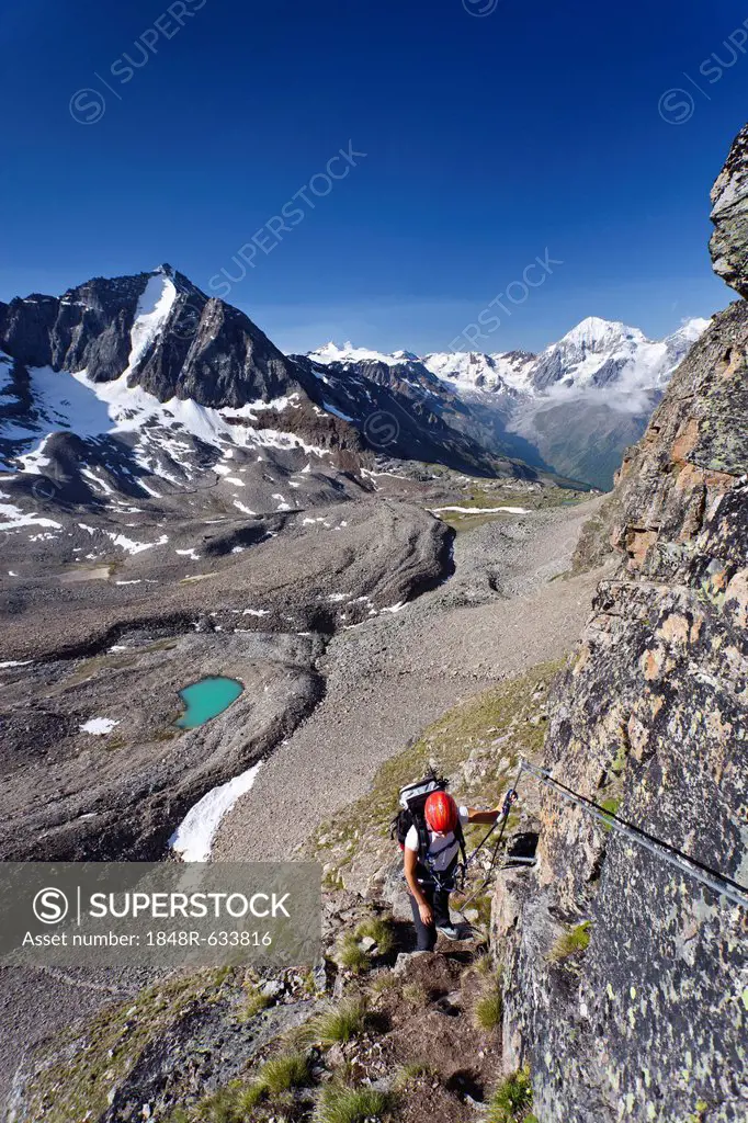 Hiker ascending Mt Tschenglser Hochwand or Croda di Cengles over the via ferrata, above the Duesseldorfhuette or Rifugio Serristori in Sulden, Solda, ...