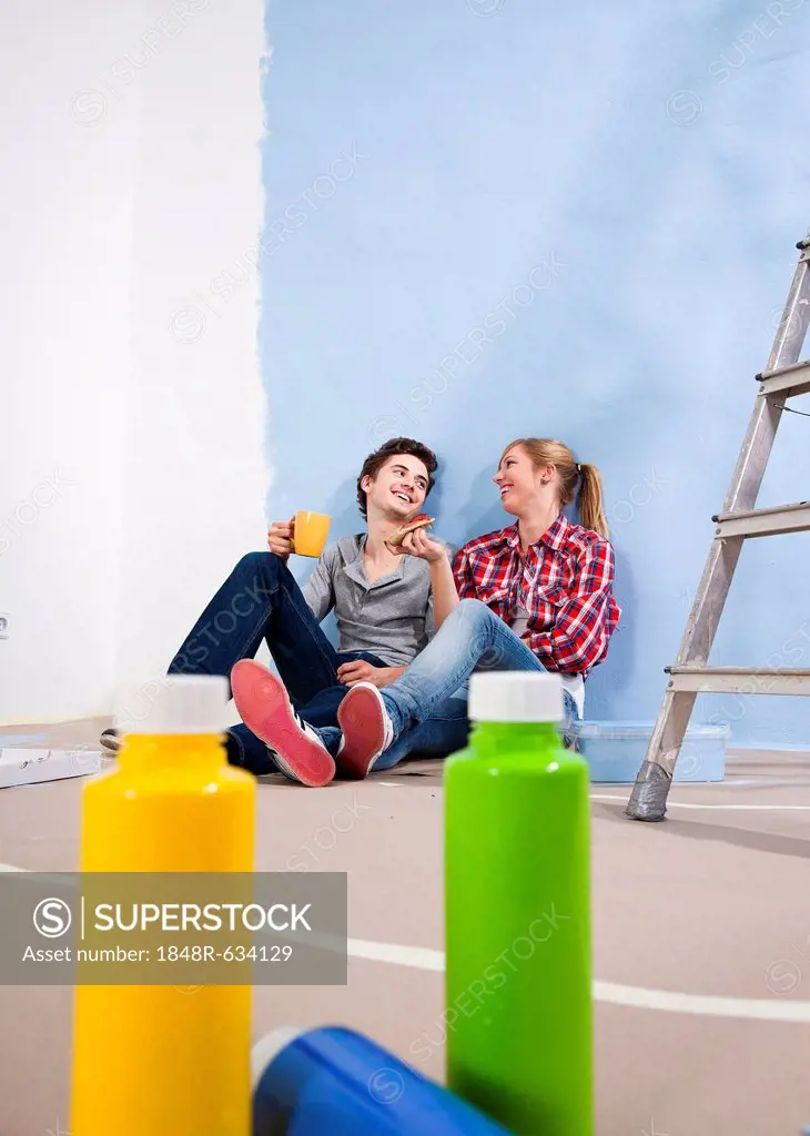 Young couple taking a break during a renovation