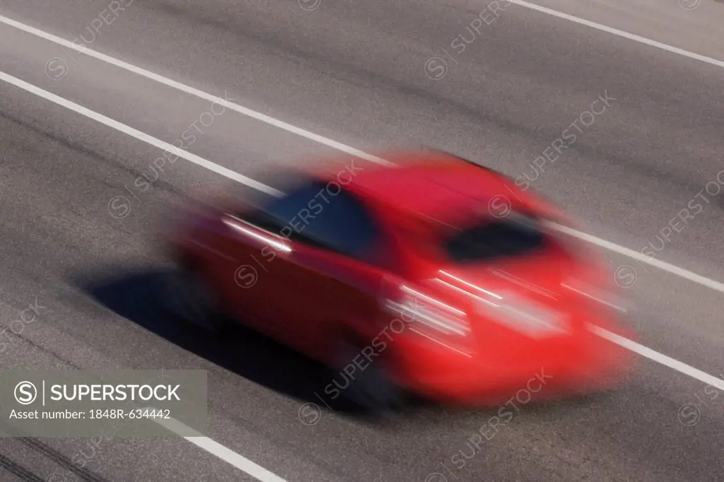 Red car in motion on a highway, Quebec, Canada