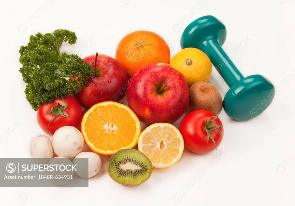 Fruit and vegetables with a dumbbell