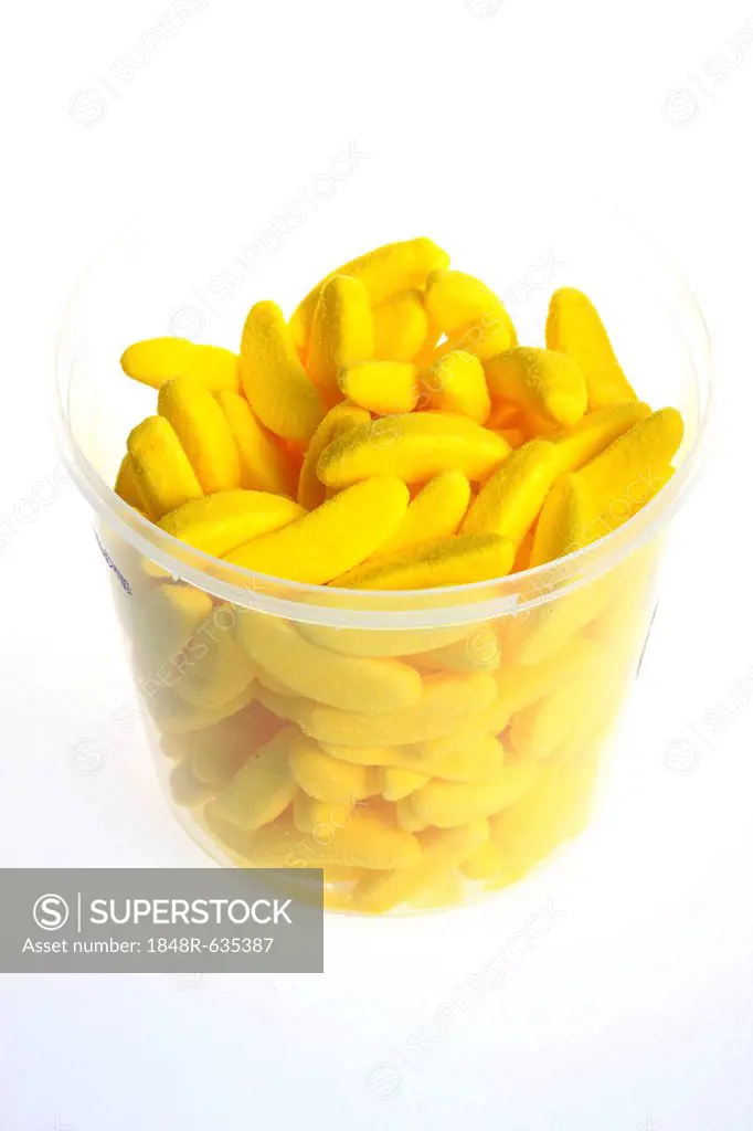 Yellow candy bananas in a clear cup