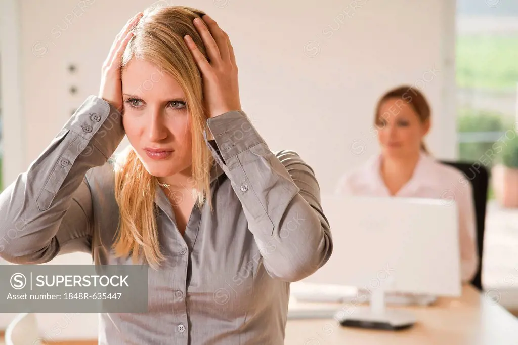 Colleagues in office, stressed woman