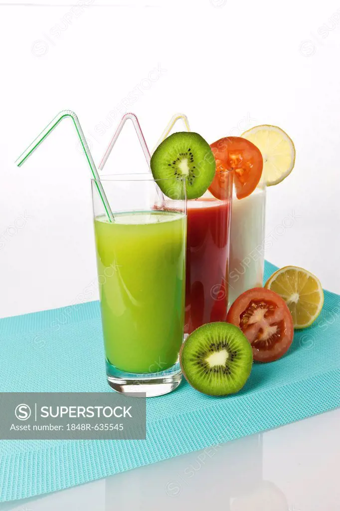 Kiwi and lemon yogurt drinks and tomato juice in glasses with fruit