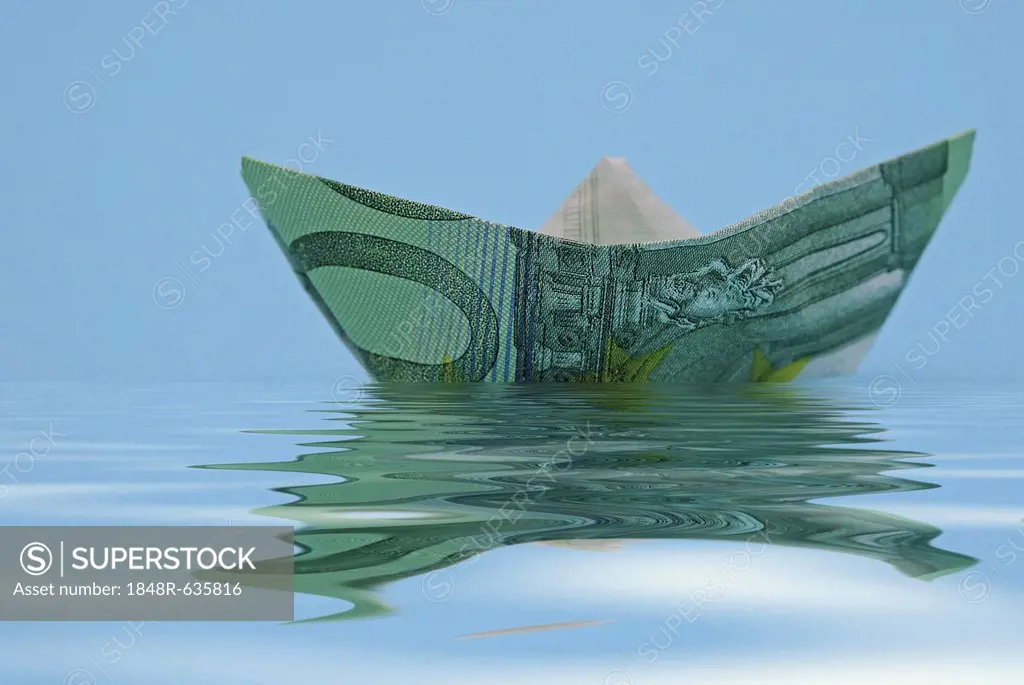 Paper boat folded from a euro banknote, symbolic image for a ship cruise or vacation pay