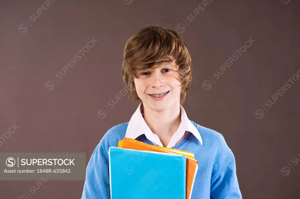 Boy holding school books