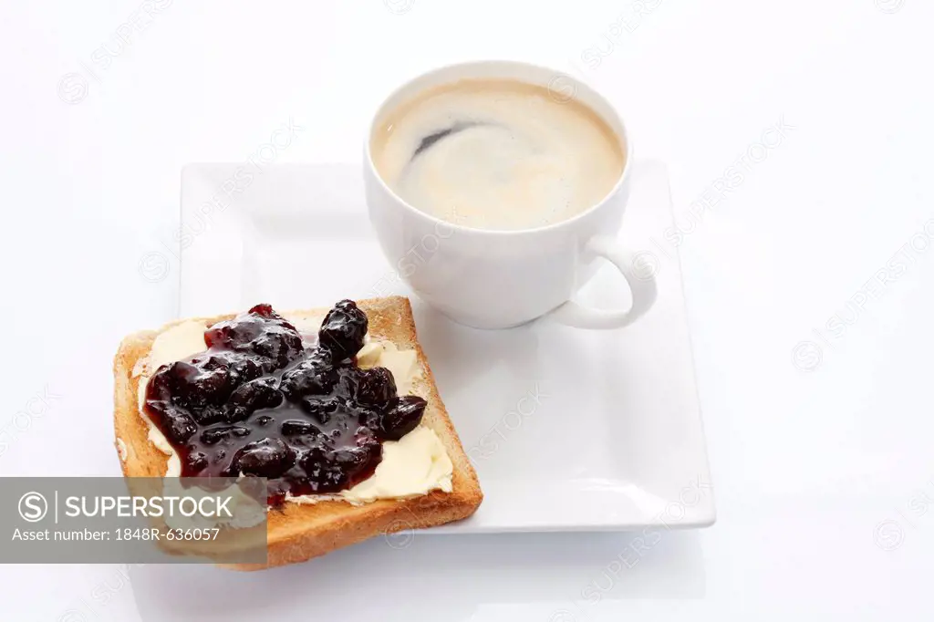 Porcelain plate with a cup of coffee and toast with cherry jam