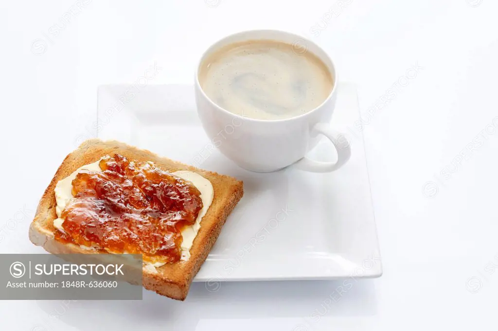 Porcelain plate with a cup of coffee and toast with apricot jam