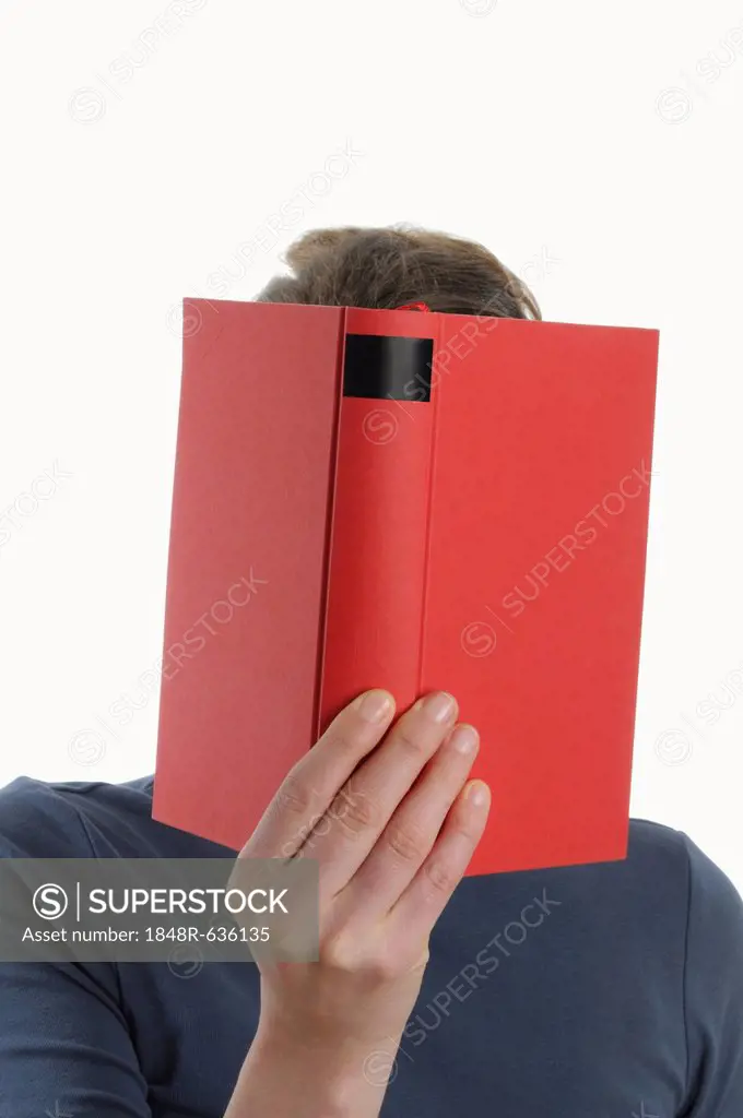 Woman with a red book in front of her face