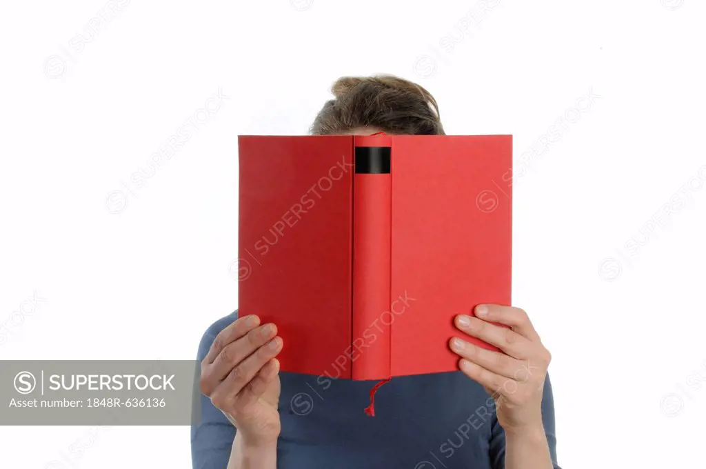 Woman with a red book in front of her face