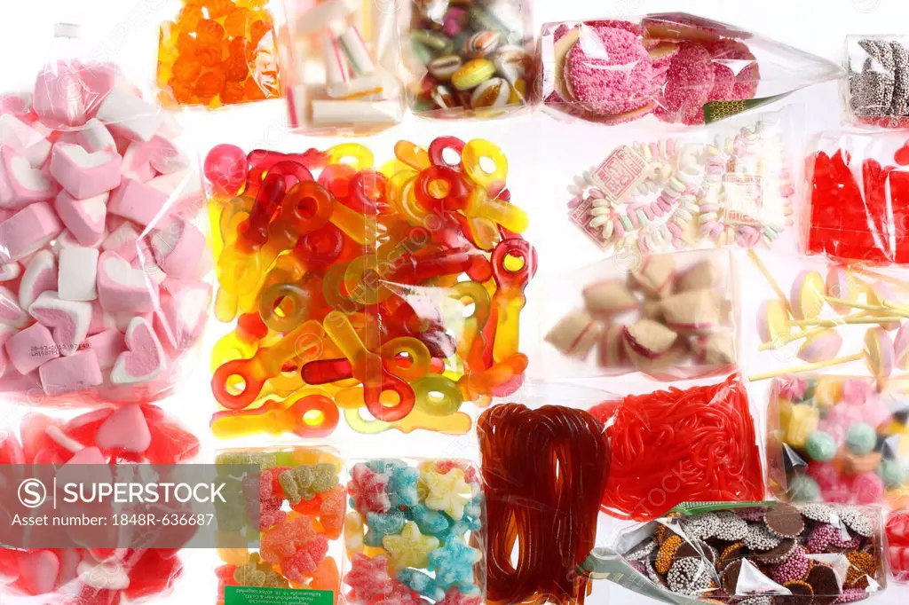 Clear plastic bags with a variety of fruit gums, marshmallows, candies, lollipops, cookies and gummy bears